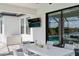 This covered outdoor patio offers a television and views of the pool, lake, and garden at 11435 Apple Tree Cir, Bradenton, FL 34211