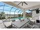 Relax on the screened patio with views of the pool, lake, and surrounding landscape at 11435 Apple Tree Cir, Bradenton, FL 34211