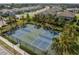 Overhead view of community pickleball courts surrounded by lush greenery and well-maintained landscaping, perfect for recreation at 11435 Apple Tree Cir, Bradenton, FL 34211