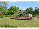 Community playground surrounded by lush greenery at 11435 Apple Tree Cir, Bradenton, FL 34211