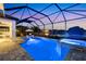 Inviting screened in pool and hot tub with lake view and lounge chairs at 11435 Apple Tree Cir, Bradenton, FL 34211