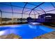 Screened in pool and hot tub with view of the lake at dusk at 11435 Apple Tree Cir, Bradenton, FL 34211