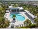 Aerial view of community pool with modern lounge area, ample seating, and lush landscaping, creating a relaxing oasis at 11435 Apple Tree Cir, Bradenton, FL 34211