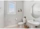 A stylish powder room features a pedestal sink, plantation shutters, and modern decor at 11435 Apple Tree Cir, Bradenton, FL 34211