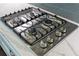Close up of stainless steel gas stovetop with four burners and modern controls at 11435 Apple Tree Cir, Bradenton, FL 34211