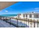 Balcony view of the beach featuring blue sky and calm water at 1212 Benjamin Franklin Dr # 708, Sarasota, FL 34236