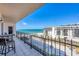 Balcony view of the beach, palm trees, and cityscape, perfect for outdoor relaxation at 1212 Benjamin Franklin Dr # 708, Sarasota, FL 34236