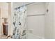 Bright bathroom with white subway tile, decorative shower curtain with starfish and seahorse design at 1212 Benjamin Franklin Dr # 708, Sarasota, FL 34236