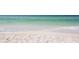 Gorgeous white sandy beach where the ocean waves meet the shore, creating a serene and tranquil environment at 1212 Benjamin Franklin Dr # 708, Sarasota, FL 34236