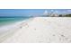 Beautiful white sandy beach with clear blue ocean water, perfect for swimming, sunbathing, and beach activities at 1212 Benjamin Franklin Dr # 708, Sarasota, FL 34236