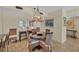 Cozy dining area with stylish wicker chairs and an elegant chandelier at 1212 Benjamin Franklin Dr # 708, Sarasota, FL 34236