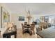 Bright dining area with table, chairs, and elegant chandelier at 1212 Benjamin Franklin Dr # 708, Sarasota, FL 34236