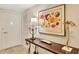 Hallway table with lamp, artwork, and golden palm tree decoration at 1212 Benjamin Franklin Dr # 708, Sarasota, FL 34236