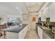 Open kitchen with granite counters, modern appliances, and seamless flow into the living area at 1212 Benjamin Franklin Dr # 708, Sarasota, FL 34236