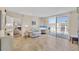 Inviting living room featuring a balcony view, tiled floors, and comfortable seating at 1212 Benjamin Franklin Dr # 708, Sarasota, FL 34236
