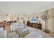 Open concept living room, dining room with large TV and comfortable furnishings at 1212 Benjamin Franklin Dr # 708, Sarasota, FL 34236
