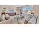 Comfortable living room with sofas, rug, and a view of the beach from the patio at 1212 Benjamin Franklin Dr # 708, Sarasota, FL 34236