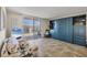 Cozy living room with beach-themed decor, balcony access, and built-in storage at 1212 Benjamin Franklin Dr # 708, Sarasota, FL 34236