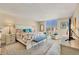 Spacious main bedroom with large windows and sitting area at 1212 Benjamin Franklin Dr # 708, Sarasota, FL 34236