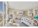 Bright main bedroom with seating and large windows at 1212 Benjamin Franklin Dr # 708, Sarasota, FL 34236