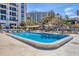 Bright pool area with clear water and tropical views creating the perfect place to relax and unwind with lush palm trees at 1212 Benjamin Franklin Dr # 708, Sarasota, FL 34236