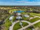 Stunning aerial view of the home surrounded by lush greenery, a lake, and unique architectural features at 12305 Harland St, North Port, FL 34287