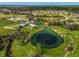Scenic aerial view of a property featuring a natural lake surrounded by lush landscapes at 12305 Harland St, North Port, FL 34287