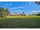 Expansive backyard perfect for outdoor activities, featuring lush green grass, storage shed and brick home at 12305 Harland St, North Port, FL 34287