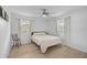 Bright bedroom with white walls, hardwood floors, and a modern ceiling fan at 12305 Harland St, North Port, FL 34287