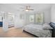 Bedroom featuring ceiling fan, natural light, and an ensuite bathroom at 12305 Harland St, North Port, FL 34287