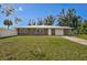 Charming single-story brick home with a well-manicured lawn and a freshly painted white metal roof at 12305 Harland St, North Port, FL 34287