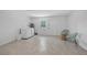 Bright laundry room with epoxy floors, a washing machine and dryer, and woven-design chairs at 12305 Harland St, North Port, FL 34287