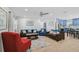Bright, open living room with comfortable seating, modern decor, and seamless transition to a stylish kitchen area at 12305 Harland St, North Port, FL 34287