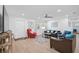 Open living area with hardwood floors, modern sofas, area rug, and large television for easy entertaining at 12305 Harland St, North Port, FL 34287