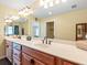 Bathroom features a double vanity with ample countertop space and a large mirror with stylish lighting at 1248 Northport Dr, Sarasota, FL 34242