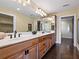 A full bathroom featuring dual sinks, wooden cabinets and a large mirror at 1248 Northport Dr, Sarasota, FL 34242