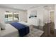 This bedroom features a sliding glass door, a white dresser, and views of the pool at 1248 Northport Dr, Sarasota, FL 34242
