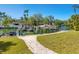Dock featuring a boat and jet skis in a tranquil waterfront setting surrounded by lush greenery at 1248 Northport Dr, Sarasota, FL 34242