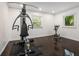 Spacious home gym with dark wood floor and natural light through the windows at 1248 Northport Dr, Sarasota, FL 34242