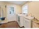 Laundry room features a washing machine, dryer, sink, window, and outside access at 1248 Northport Dr, Sarasota, FL 34242