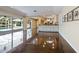 Bright living room with open floor plan featuring polished floors with seamless access to screened pool at 1248 Northport Dr, Sarasota, FL 34242