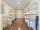 Walk-in pantry with metal shelves, white storage baskets, and concrete floors at 1248 Northport Dr, Sarasota, FL 34242