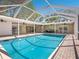 The property features a refreshing screened-in pool area with ample space for lounging and entertaining at 1248 Northport Dr, Sarasota, FL 34242