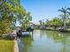 Picturesque canal waterfront view with boats docked, surrounded by lush greenery and clear skies at 1248 Northport Dr, Sarasota, FL 34242