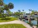 Scenic waterfront view with a boat dock and jet skis, showcasing a serene, tropical landscape at 1248 Northport Dr, Sarasota, FL 34242