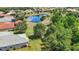 An aerial view of the home situated near a scenic pond, lush trees, and well-kept lawns at 12628 Daisy Pl, Bradenton, FL 34212