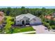 Aerial view of the house showcasing its meticulously landscaped surroundings and tile roof at 12628 Daisy Pl, Bradenton, FL 34212