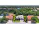 Aerial view of a neighborhood featuring mature trees, pristine lakes, and green lawns at 12628 Daisy Pl, Bradenton, FL 34212