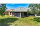 An appealing screened in lanai is featured in the backyard of this home with verdant lawn at 12628 Daisy Pl, Bradenton, FL 34212