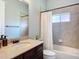 Bathroom with vanity, sink, tiled shower-tub combination and modern fixtures at 12628 Daisy Pl, Bradenton, FL 34212